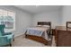 Comfortable bedroom with natural light, neutral walls and carpet, a bed and side tables at 3759 Chapel Cv, Douglasville, GA 30135