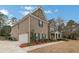 Charming two-story home featuring a brick facade, attached garage, and beautifully landscaped front yard at 3759 Chapel Cv, Douglasville, GA 30135