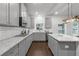 Well-lit kitchen with grey cabinets, white countertops, stainless appliances, and hardwood floors at 3759 Chapel Cv, Douglasville, GA 30135