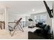 Carpeted loft space with an inversion table, treadmill, tv, and a sofa at 3759 Chapel Cv, Douglasville, GA 30135