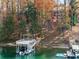 Exterior shot of a private boat dock with boat lift, stairs, and lake access at 6178 Lake Lanier Heights Rd, Buford, GA 30518