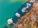 Scenic aerial view of waterfront property with multiple docks and recreational boats at 6178 Lake Lanier Heights Road, Buford, GA 30518