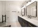 Modern bathroom with a double sink vanity, marble countertops, and sleek fixtures at 6178 Lake Lanier Heights Road, Buford, GA 30518