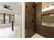 Elegant bathroom featuring a glass-enclosed shower with dark tile and modern fixtures at 6178 Lake Lanier Heights Road, Buford, GA 30518