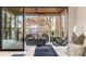 Relaxing bedroom boasts sliding glass doors to a cozy outdoor living area with stunning lake views at 6178 Lake Lanier Heights Road, Buford, GA 30518