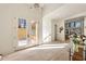 Sun-drenched entryway features light wood floors, modern lighting, and double doors that bring the outdoors in at 6178 Lake Lanier Heights Road, Buford, GA 30518