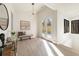 Bright entryway boasts light wood floors, modern light fixture, bench, and double glass doors leading to a patio at 6178 Lake Lanier Heights Road, Buford, GA 30518