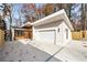 Modern home with a spacious driveway and a two-car garage at 6178 Lake Lanier Heights Road, Buford, GA 30518