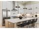 Beautiful kitchen features sleek stainless-steel appliances, a spacious island with seating, and modern pendant lighting at 6178 Lake Lanier Heights Road, Buford, GA 30518