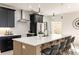 Modern kitchen features stainless appliances, quartz countertops, and eat-in bar seating at 6178 Lake Lanier Heights Road, Buford, GA 30518