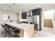Modern kitchen with stainless fridge, quartz countertop, and eat-in bar at 6178 Lake Lanier Heights Road, Buford, GA 30518