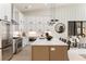 Open kitchen featuring an island with seating, stainless-steel appliances, and ample cabinet space at 6178 Lake Lanier Heights Road, Buford, GA 30518
