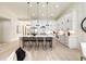Open-concept kitchen with white cabinets, an island with seating, and stainless-steel appliances at 6178 Lake Lanier Heights Road, Buford, GA 30518