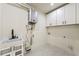Functional laundry room with modern sink, cabinets, and tankless water heater at 6178 Lake Lanier Heights Road, Buford, GA 30518