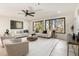 Bright living room with ample natural light, ceiling fan, and neutral decor at 6178 Lake Lanier Heights Road, Buford, GA 30518
