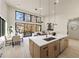 Bright living room with large windows, hardwood floors, and a modern kitchen island at 6178 Lake Lanier Heights Road, Buford, GA 30518