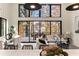 Bright living room with expansive lake views, stylish furniture, and a dining area at 6178 Lake Lanier Heights Road, Buford, GA 30518