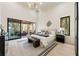Bright main bedroom featuring a private balcony, contemporary decor and large windows at 6178 Lake Lanier Heights Road, Buford, GA 30518
