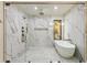 Luxurious bathroom featuring a walk-in marble shower, soaking tub, and premium fixtures at 6178 Lake Lanier Heights Road, Buford, GA 30518