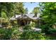 Home featuring dormer windows, covered entryway, and lush landscaping at 690 Old Ivy Ne Rd, Atlanta, GA 30342