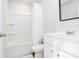 Clean bathroom with a shower-tub combo, white vanity, and fresh white tile at 269 Whitetail Cir, Canton, GA 30115