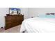 Bedroom showcasing a plush bed with neutral-tone bedding and a warm wood dresser at 269 Whitetail Cir, Canton, GA 30115