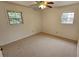 Bedroom with neutral carpet, two windows letting in natural light, and a ceiling fan fixture at 4112 Bontura Ct, Stone Mountain, GA 30083