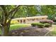 Charming brick home featuring a well-manicured front yard, complemented by mature trees and tasteful landscaping at 4112 Bontura Ct, Stone Mountain, GA 30083