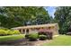 Charming brick home featuring a well-manicured front yard, complemented by mature trees and tasteful landscaping at 4112 Bontura Ct, Stone Mountain, GA 30083