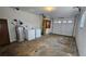 Garage including washer, dryer, water heater, and an access door to inside the home at 4112 Bontura Ct, Stone Mountain, GA 30083