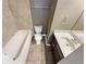 Tiled bathroom features a tub, toilet, vanity and mirror at 4954 Wyeth Way, Alpharetta, GA 30022