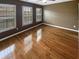 Hardwood floors, natural light, and a ceiling fan enhance this bedroom, offering comfort and style at 4954 Wyeth Way, Alpharetta, GA 30022
