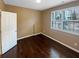 Neutral bedroom highlighting hardwood floors and a window at 4954 Wyeth Way, Alpharetta, GA 30022