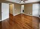 Spacious bedroom boasts gleaming hardwood floors, ceiling fan, and ample closet space for storage and organization at 4954 Wyeth Way, Alpharetta, GA 30022