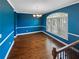 Bright dining room featuring hardwood floors, a large window and elegant chandelier lighting at 4954 Wyeth Way, Alpharetta, GA 30022