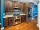 Close up on a Wolf range and stainless steel refrigerator in a chef's kitchen at 4954 Wyeth Way, Alpharetta, GA 30022
