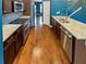 Modern kitchen featuring stainless steel appliances, granite countertops, and hardwood floors at 4954 Wyeth Way, Alpharetta, GA 30022