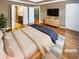 Spacious main bedroom featuring hardwood floors, modern decor, and ensuite bathroom and walk-in closet at 4954 Wyeth Way, Alpharetta, GA 30022