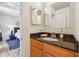 This bathroom contains wood cabinets and a blue accent rug at 1445 Monroe Ne Dr # A12, Atlanta, GA 30324