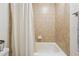 A tub shower with tan tile is present in the bathroom at 1445 Monroe Ne Dr # A12, Atlanta, GA 30324
