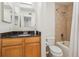 Bathroom with black granite vanity, light wood cabinetry, and shower/tub combo at 1445 Monroe Ne Dr # A12, Atlanta, GA 30324