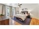 Bedroom with hardwood floors, ceiling fan, full bed, and direct backyard access at 1445 Monroe Ne Dr # A12, Atlanta, GA 30324