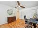 Inviting bedroom with hardwood floors, ceiling fan, closet, dresser and office setup at 1445 Monroe Ne Dr # A12, Atlanta, GA 30324