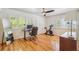 Bright bedroom with hardwood floors, plantation shutters, ceiling fan, and office space at 1445 Monroe Ne Dr # A12, Atlanta, GA 30324