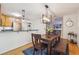 Cozy dining room with wooden furniture, stylish lighting, and open access to the kitchen at 1445 Monroe Ne Dr # A12, Atlanta, GA 30324