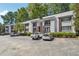 Modern two-story exterior elevation with decorative balconies, mature trees, and ample parking at 1445 Monroe Ne Dr # A12, Atlanta, GA 30324