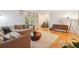 Sunlit living room featuring hardwood floors, neutral decor, and access to a balcony at 1445 Monroe Ne Dr # A12, Atlanta, GA 30324