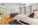 This main bedroom features hardwood floors, a ceiling fan, and access to an outdoor patio at 1445 Monroe Ne Dr # A12, Atlanta, GA 30324