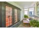 The screened in porch allows for relaxing outside with a sofa and coffee table at 1445 Monroe Ne Dr # A12, Atlanta, GA 30324