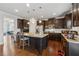 A spacious kitchen features stainless steel appliances, granite countertops, dark cabinets, and wood flooring at 2875 Bluestone Sw Dr, Atlanta, GA 30331